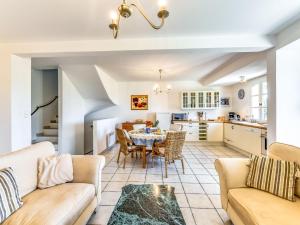 a kitchen and living room with a table and chairs at Holiday Home Les Migraniers by Interhome in Grimaud