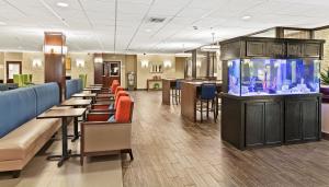 a lobby with a fish tank and a restaurant at Comfort Inn Syosset-Long Island in Syosset