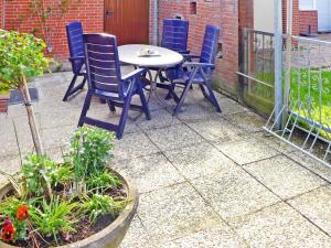 a table and chairs sitting on a patio at Holiday Home Gila by Interhome in Dornumersiel