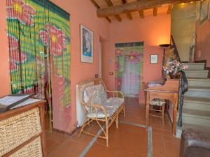 a living room with a chair and a desk at Holiday Home Tara by Interhome in Laterina