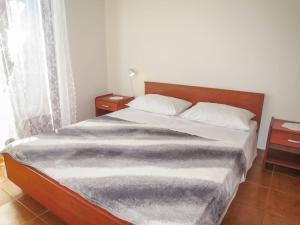 a bedroom with a large bed with two pillows at Holiday Home Bokolj - PSM154 by Interhome in Dobropoljana