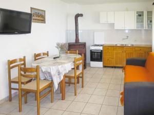 a kitchen with a table and chairs and a stove at Holiday Home Bokolj - PSM154 by Interhome in Dobropoljana