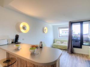 a kitchen with a table with bowls of food on it at Studio Les Marinas-4 by Interhome in Deauville