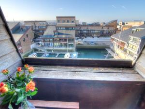 a view of a city from a window with flowers at Studio Les Marinas-4 by Interhome in Deauville