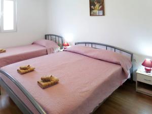 a bedroom with two beds with slippers on them at Holiday Home Franko 1 - MDN182 by Interhome in Ližnjan