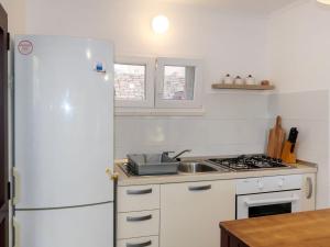 a kitchen with a white refrigerator and a sink at Holiday Home Neli - ISO305 by Interhome in Rogač