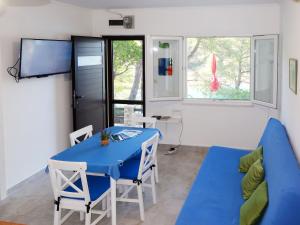 a living room with a blue table and a couch at Holiday Home Neli - ISO305 by Interhome in Rogač
