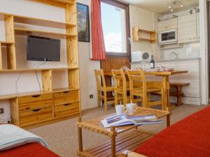 a living room with a table and a dining room at Apartment Les Tommeuses-24 by Interhome in Tignes