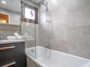 a bathroom with a shower and a bath tub at Apartment Les Tommeuses-24 by Interhome in Tignes