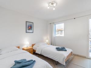 En eller flere senge i et værelse på Apartment Bougainville C3-R by Interhome
