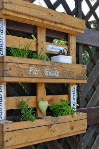 a wooden garden box with plants in it at Apartment Ferienhof Peters-1 by Interhome in Funnixer Neue Mitteldeich