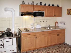a kitchen with wooden cabinets and a sink at Apartment Tillisch by Interhome in Sasbachwalden