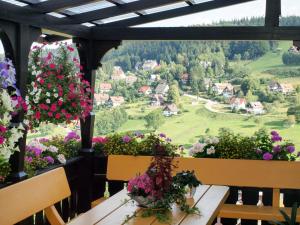 a balcony with flowers and a table and chairs at Apartment Tillisch by Interhome in Sasbachwalden