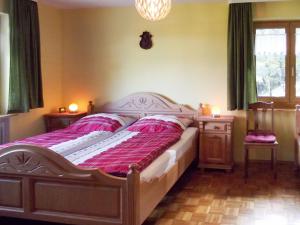ein Schlafzimmer mit einem großen Bett mit rosa Bettwäsche in der Unterkunft Apartment Tillisch by Interhome in Sasbachwalden