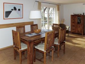 a dining room with a wooden table and chairs at Holiday Home Katja by Interhome in Ostseebad Karlshagen