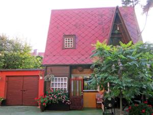 a red roofed house with a red garage at Holiday Home Mały Domek by Interhome in Darłowo