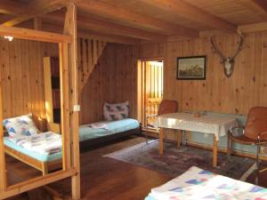 a bedroom with two beds and a table in a room at Holiday Home Mały Domek by Interhome in Darłowo