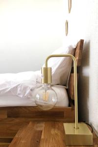 a lamp sitting on the floor next to a bed at Apartment Ringstrasse - Utoring-3 by Interhome in Leukerbad