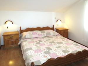 a bedroom with a bed and two night stands at Apartment Ivamar-2 by Interhome in Jezera