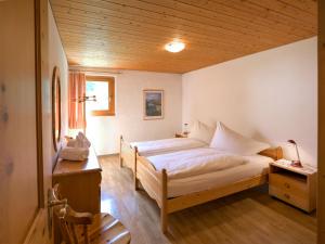 a bedroom with a large bed and a wooden ceiling at Apartment Chesa Maurus A1 by Interhome in St. Moritz