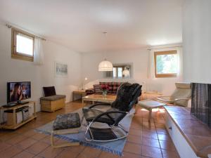 a living room with a couch and a table at Apartment Chesa Maurus A1 by Interhome in St. Moritz