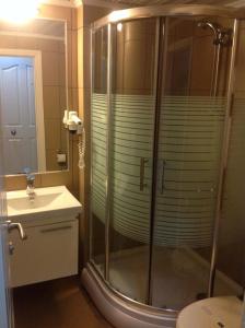 a bathroom with a shower and a sink at Sunset Hotel Dikili in Dikili