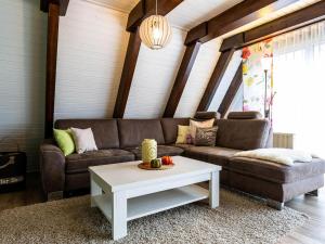 a living room with a couch and a coffee table at Holiday Home Ferienwohnpark Immenstaad-1 by Interhome in Immenstaad am Bodensee