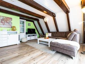 a living room with a couch and a tv at Holiday Home Ferienwohnpark Immenstaad-1 by Interhome in Immenstaad am Bodensee