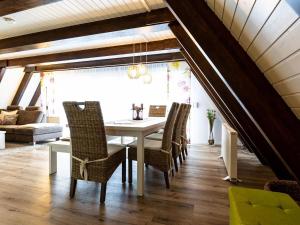 a dining room with a white table and chairs at Holiday Home Ferienwohnpark Immenstaad-1 by Interhome in Immenstaad am Bodensee