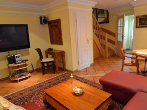 a living room with a couch and a tv at Holiday Home Lotsenhaus by Interhome in Groß Zicker