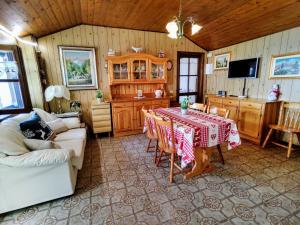a living room with a table and a kitchen at Holiday Home Baita dei Nonni-3 by Interhome in Livo