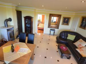 a living room with a couch and a table at Apartment Sonnenkliff-1 by Interhome in Groß Zicker +27 photos