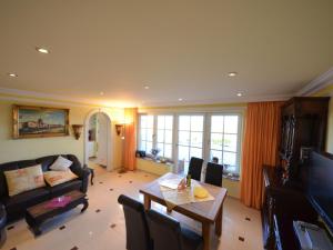 a living room with a couch and a table at Apartment Sonnenkliff-1 by Interhome in Groß Zicker