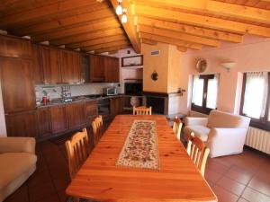 a kitchen with a long wooden table and chairs at Apartment Formaga-1 by Interhome in Gargnano