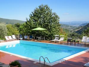 uma piscina com cadeiras e um guarda-sol em Holiday Home Il Monte-1 by Interhome em Monte Santa Maria Tiberina