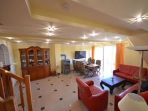 a living room with a red couch and a table at Apartment Sonnenkamp-4 by Interhome in Groß Zicker