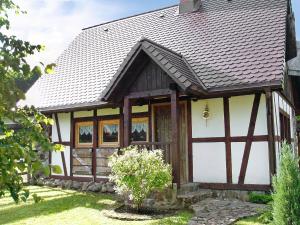 a small house with a brown roof at Holiday Home Sianowska Huta by Interhome in Prokowo