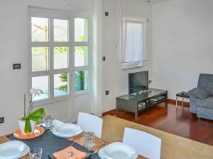 a dining room with a table and chairs and a tv at Apartment Jadranka-1 by Interhome in Rab