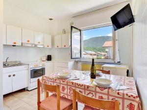 a kitchen with a table with chairs and a window at Apartment Agostini-1 by Interhome in Caldonazzo