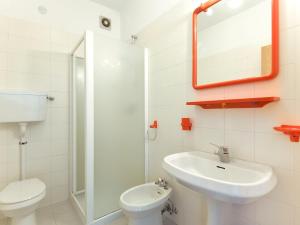 a bathroom with a sink and a toilet and a mirror at Apartment Agostini-1 by Interhome in Caldonazzo