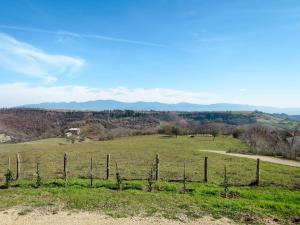 a fence in a field with mountains in the background at Holiday Home Pasqualino by Interhome in Bagnoregio