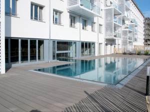 an external view of a building with a swimming pool at Apartment Mariandl am Meer-2 by Interhome in Binz