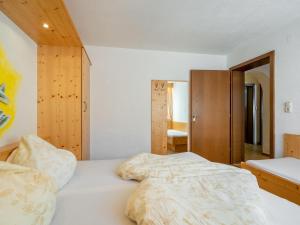 a bedroom with a large bed with white sheets at Apartment Nadine-8 by Interhome in Sölden