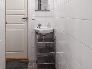 a bathroom with a sink next to a door at Holiday Home Kaukosaaren ahonlaita by Interhome in Ruka