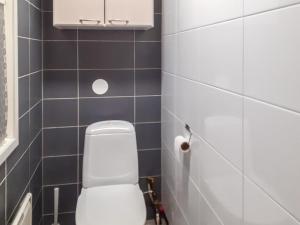 a bathroom with a white toilet and blue tiles at Holiday Home Kaukosaaren ahonlaita by Interhome in Ruka