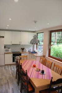 a kitchen with a wooden table and a table and chairs at Holiday Home Karpacz Kowary by Interhome in Kowary