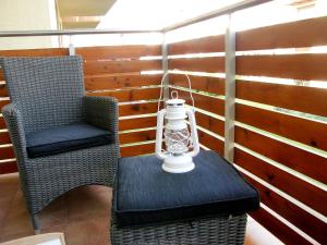 a lamp sitting on a table next to a chair at Apartment Na Wczasowej by Interhome in Ustka