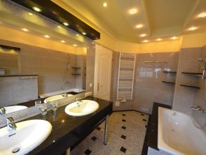 a bathroom with two sinks and a tub at Holiday Home Bel Air by Interhome in Gager
