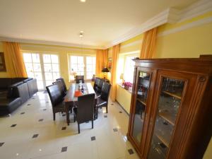 a living room with a dining room table and chairs at Holiday Home Bel Air by Interhome in Gager +24 photos