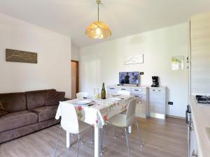 a living room with a table with chairs and a couch at Apartment Anna-1 by Interhome in Caldonazzo